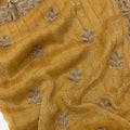 Close-up of gold fabric with silver leaf embroidery