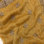 Close-up of gold fabric with silver leaf embroidery