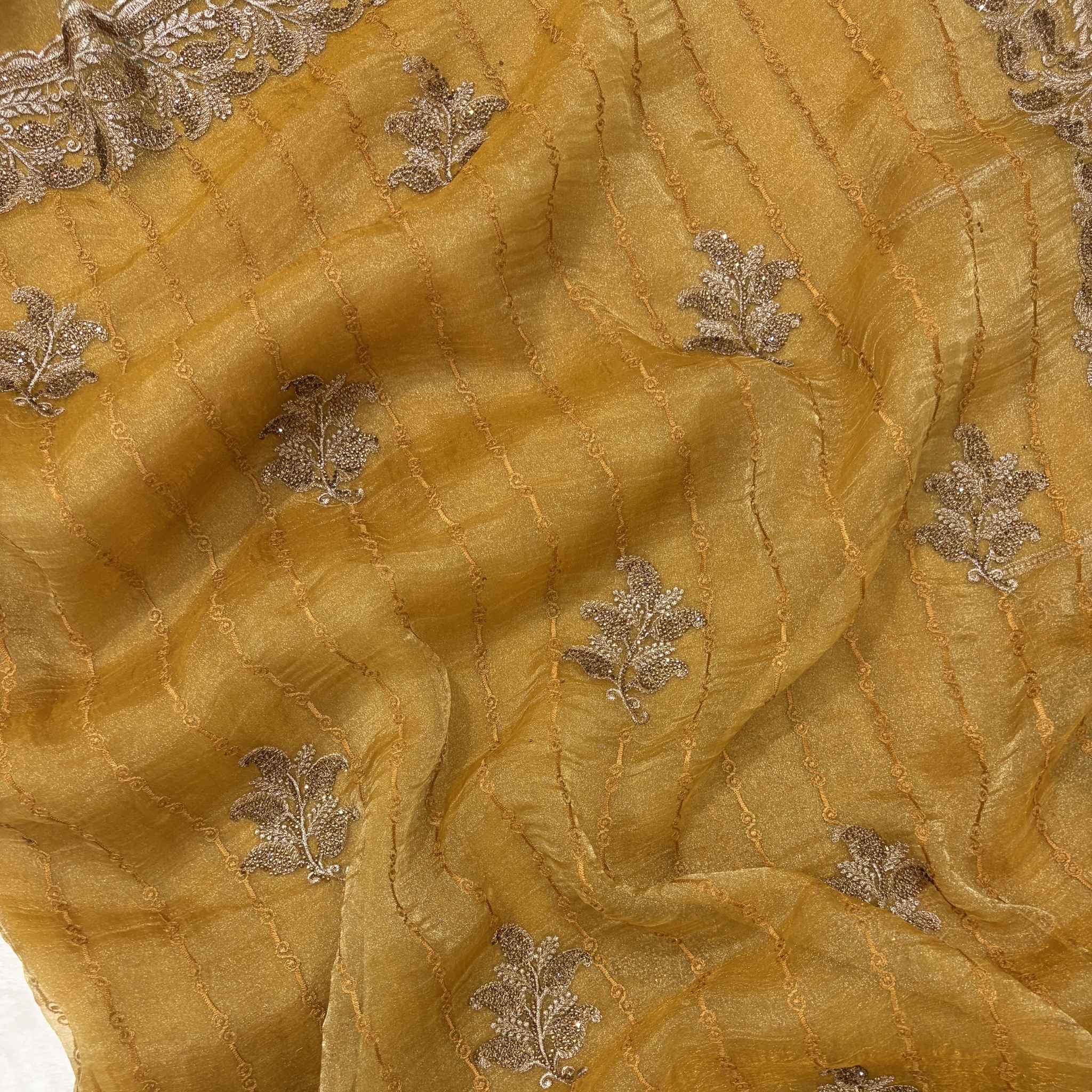 Close-up of gold fabric with silver leaf embroidery