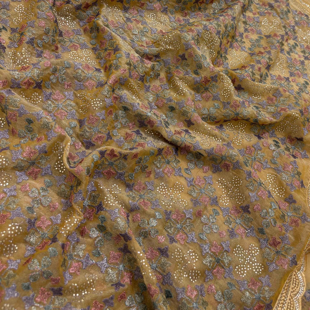 Close-up of patterned fabric with floral and geometric designs.