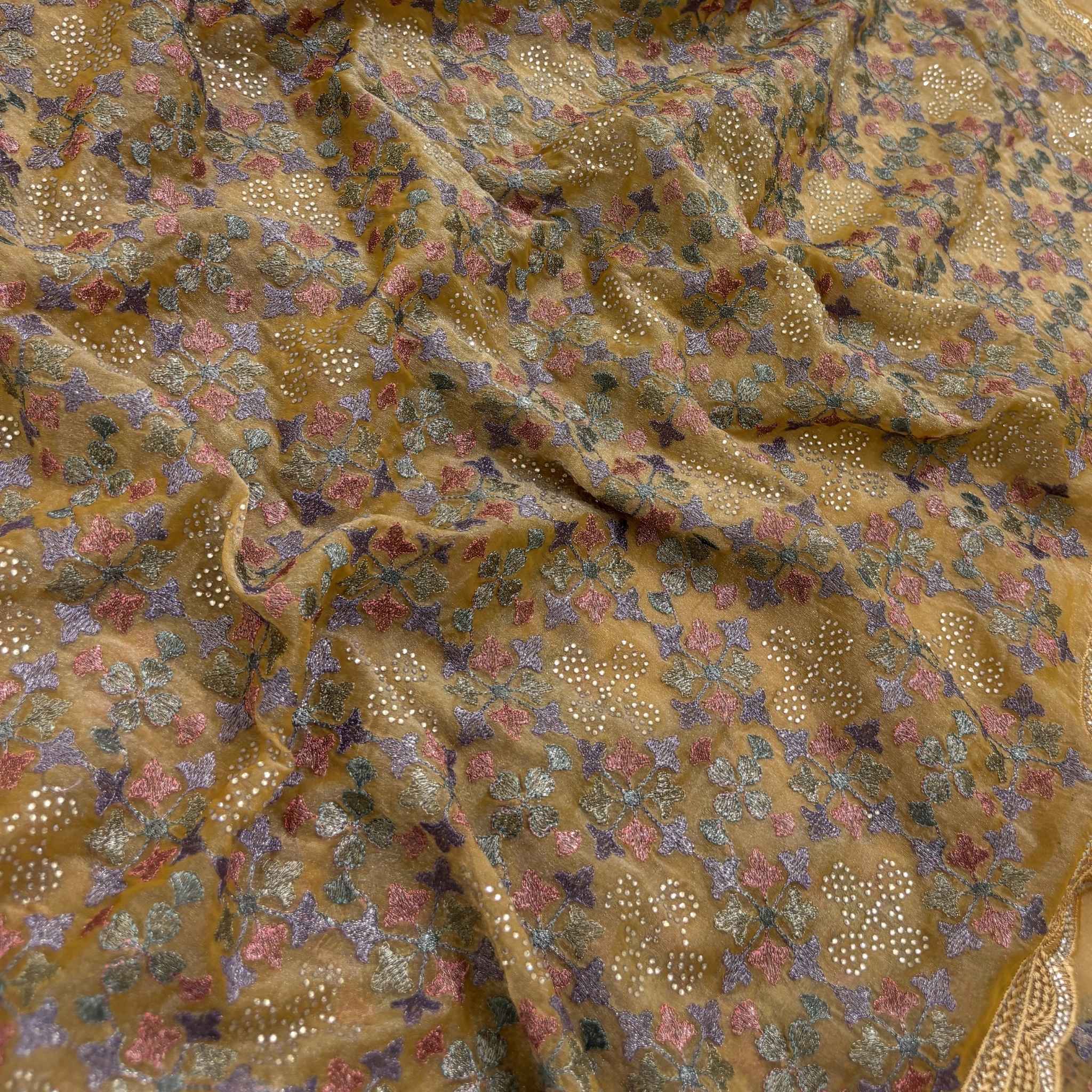 Close-up of patterned fabric with floral and geometric designs.