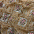 Close-up of embroidered fabric with floral patterns and gold accents