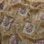 Close-up of embroidered fabric with floral patterns and gold accents