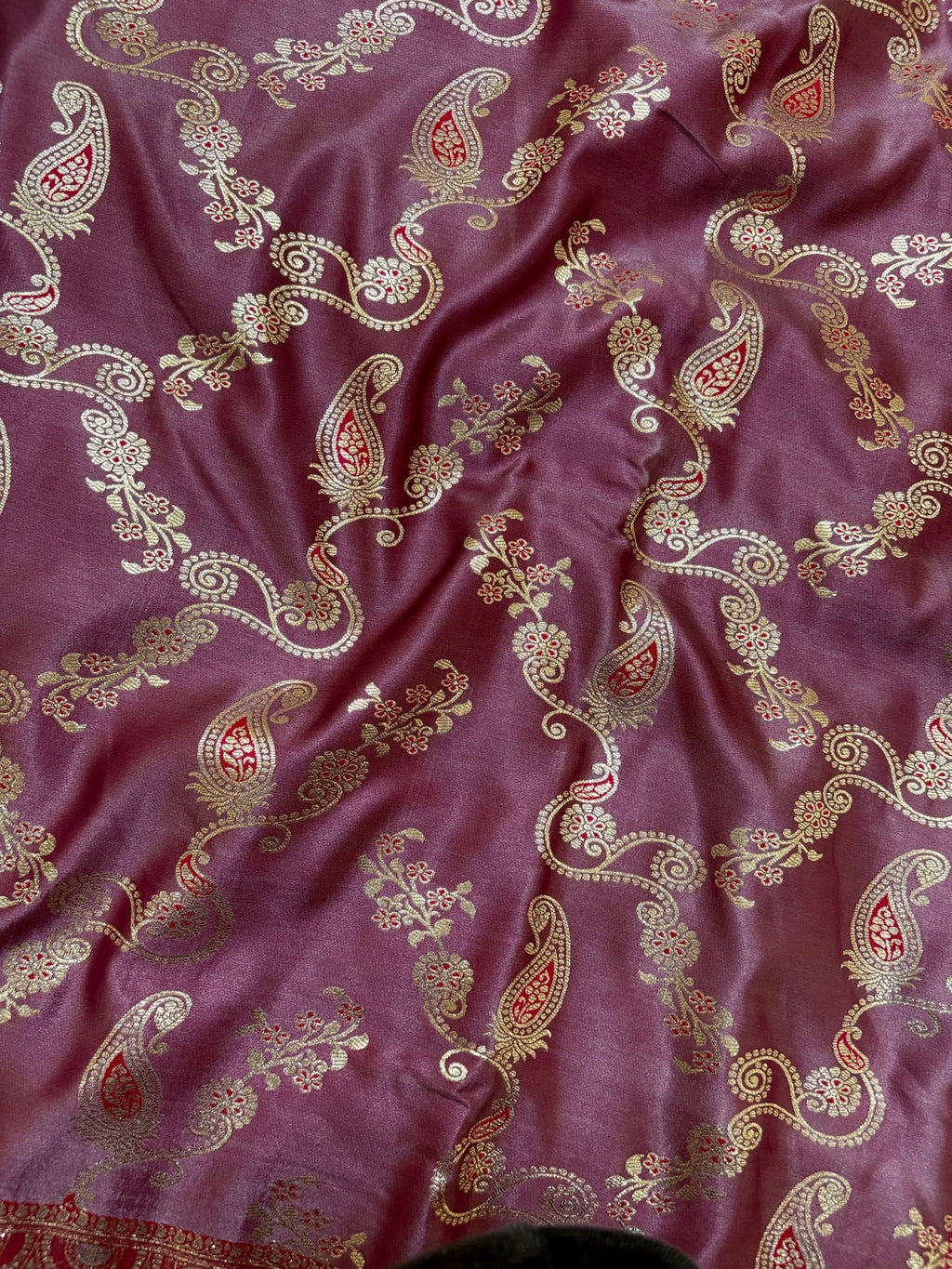 Purple fabric with intricate paisley patterns