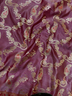 Purple fabric with intricate paisley patterns