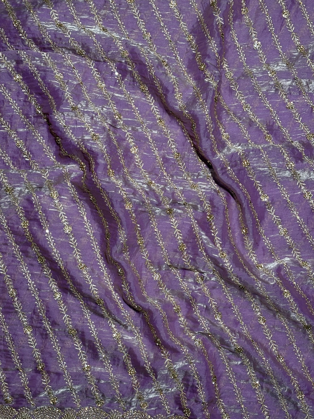 Close-up of purple fabric with gold thread