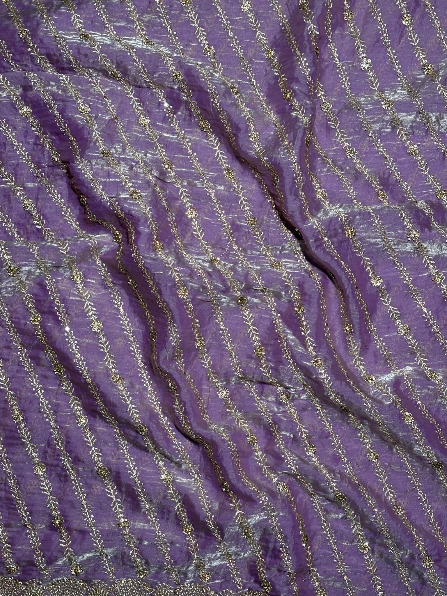 Close-up of purple fabric with gold thread