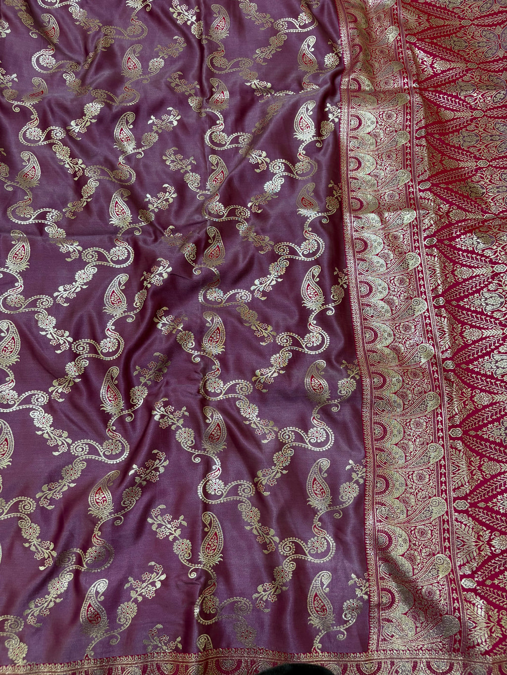 Purple fabric with intricate gold and red patterns