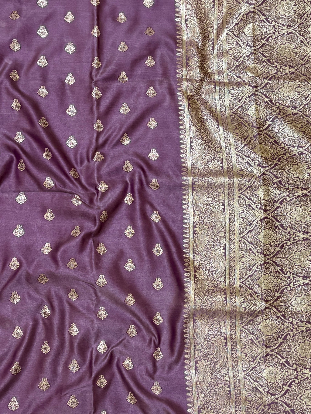 Purple fabric with gold embroidery and a patterned border