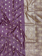 Purple fabric with gold embroidery and a patterned border