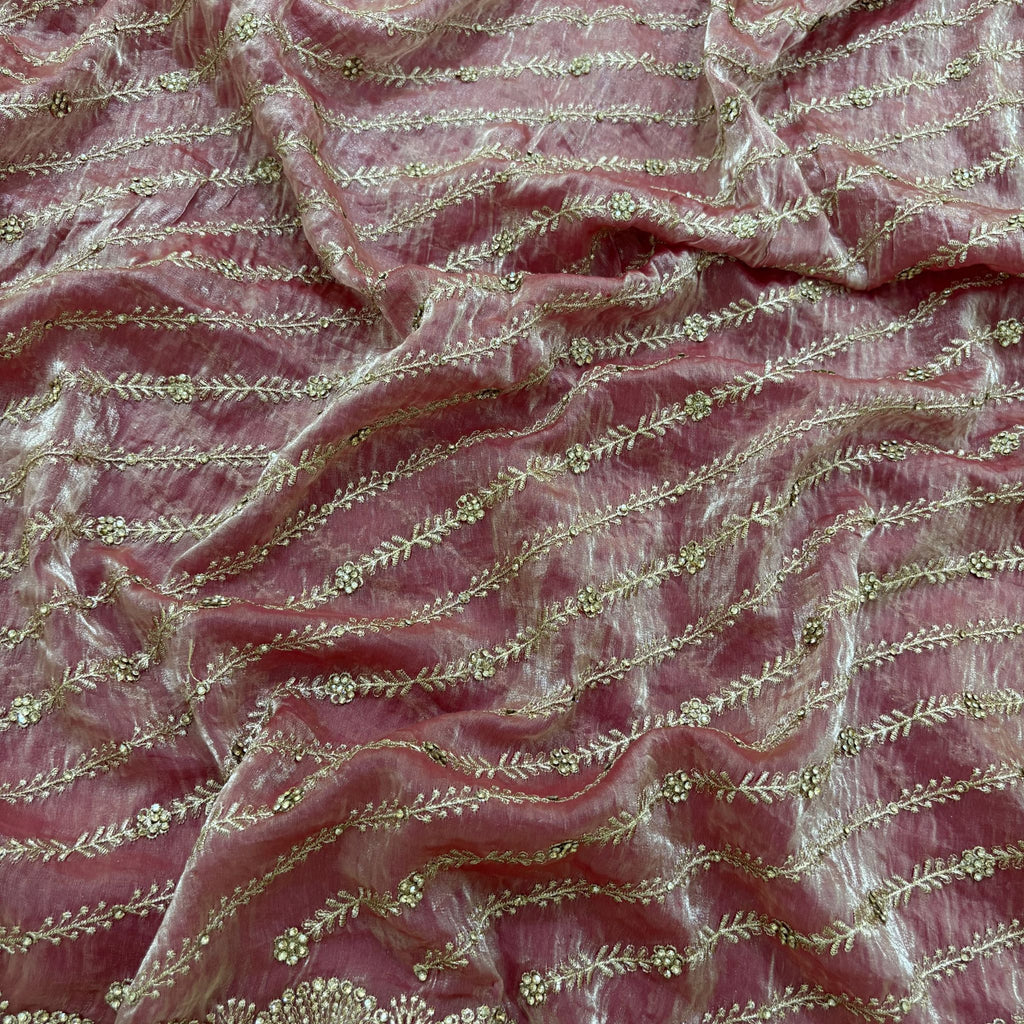 Pink fabric with gold embroidery pattern